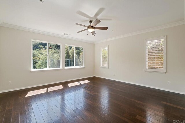 unfurnished room featuring dark wood-style floors, visible vents, baseboards, ceiling fan, and crown molding