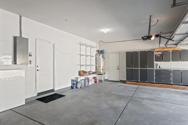 garage with water heater and a garage door opener