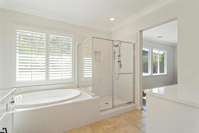 bathroom with a stall shower, a garden tub, ornamental molding, and tile patterned flooring