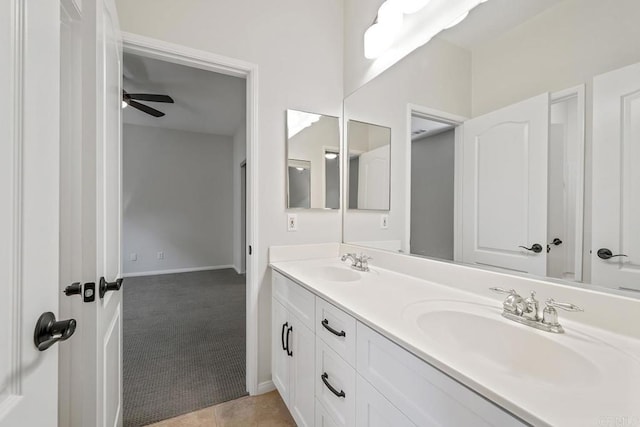 full bath with tile patterned floors, double vanity, a ceiling fan, and a sink