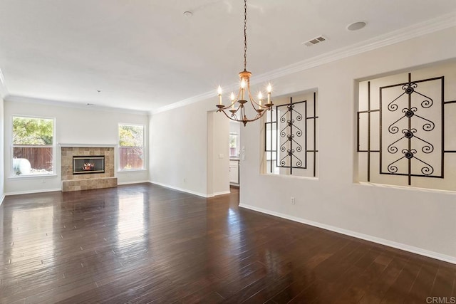 unfurnished living room featuring visible vents, wood finished floors, a fireplace, and ornamental molding