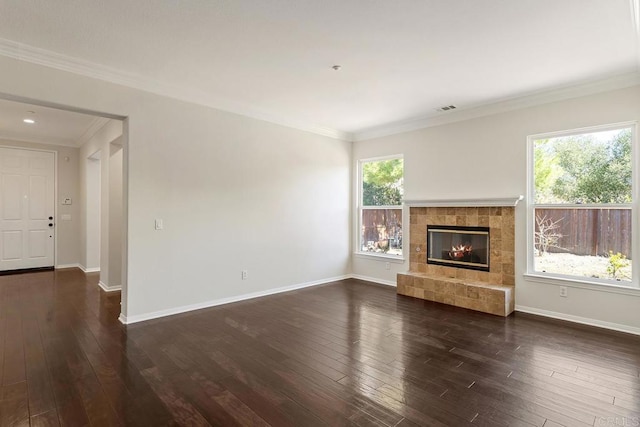 unfurnished living room featuring dark wood finished floors, a healthy amount of sunlight, and visible vents