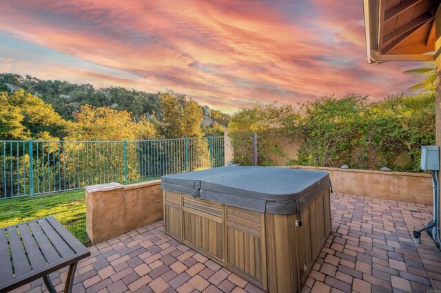 view of patio with a fenced backyard and a hot tub