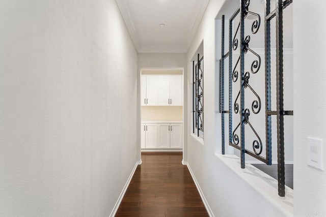 hallway featuring baseboards, ornamental molding, and dark wood-style flooring