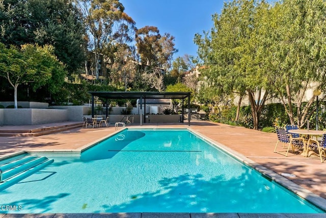 pool featuring a patio, a pergola, and fence