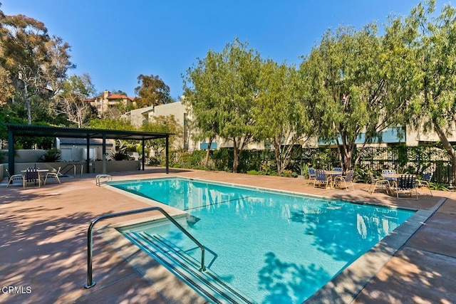 community pool featuring a patio area and fence