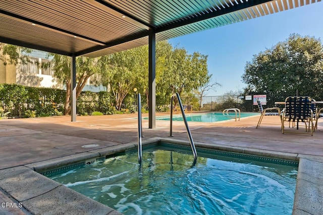 pool featuring a patio and fence