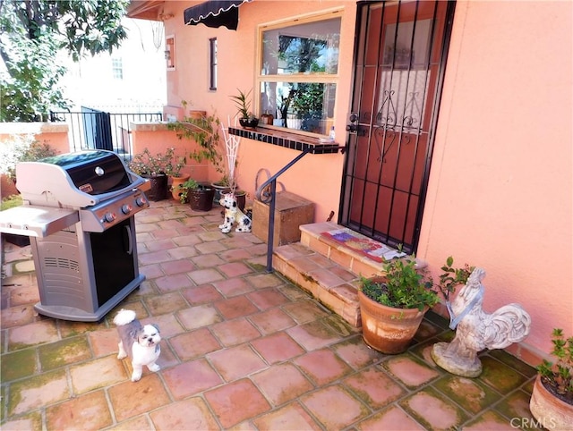 view of patio / terrace featuring a grill and fence