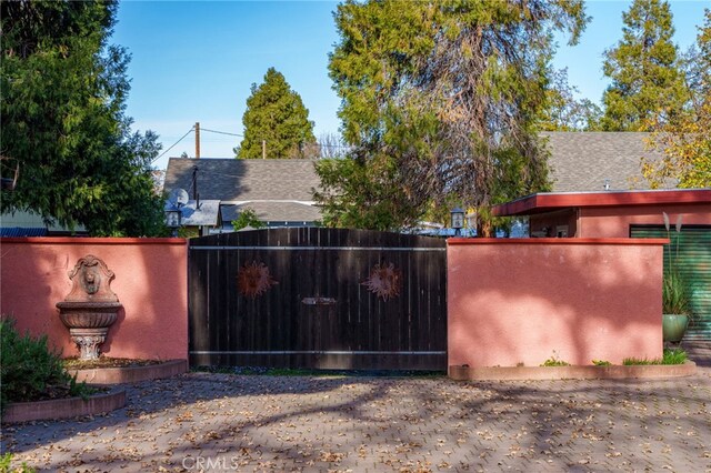 view of gate with fence