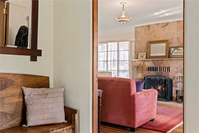 living area featuring wood finished floors and a fireplace