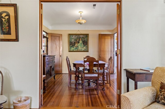 dining room with visible vents and wood finished floors