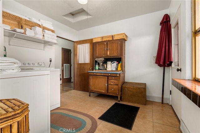 washroom featuring washer and dryer, cabinet space, light tile patterned floors, baseboards, and attic access