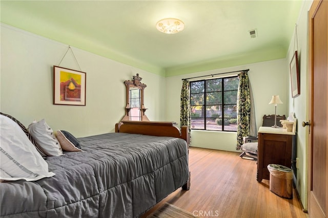 bedroom featuring light wood-style flooring and visible vents