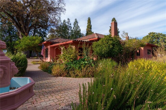 view of side of property with a tile roof