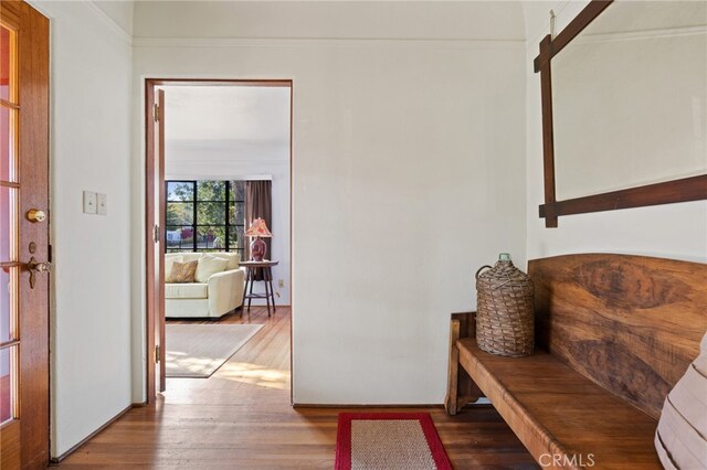 corridor featuring crown molding and wood finished floors