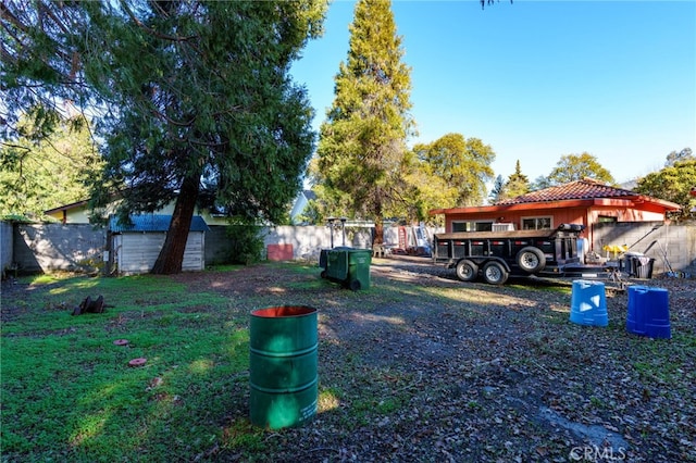 view of yard with an outbuilding and a fenced backyard