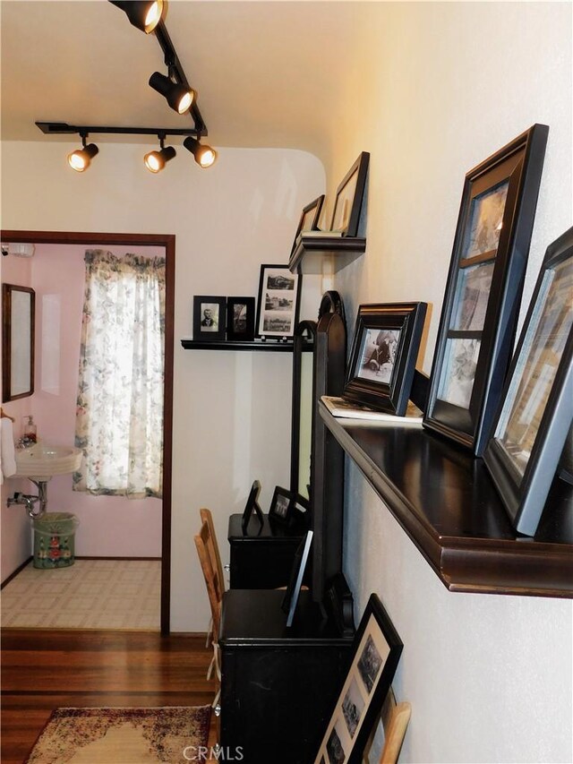 interior space featuring track lighting and wood finished floors