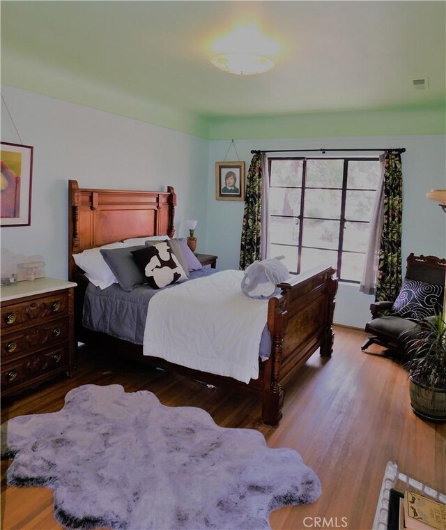 bedroom featuring wood finished floors