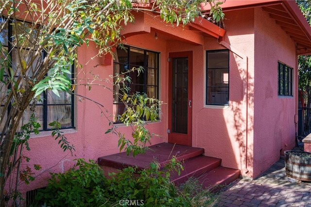 property entrance with stucco siding