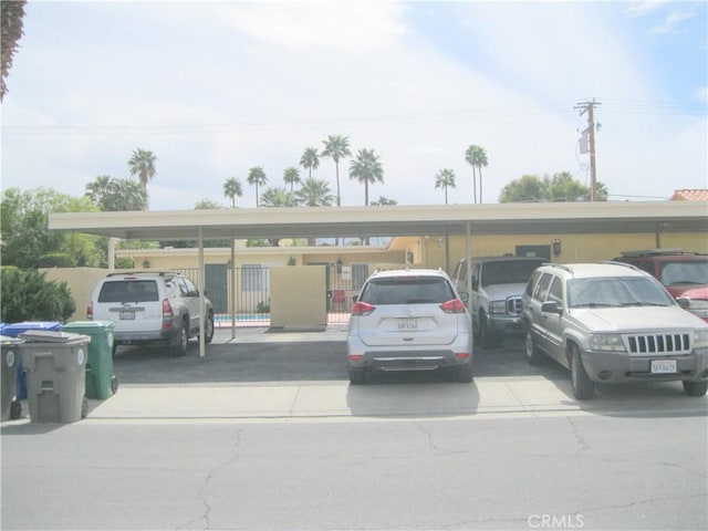 uncovered parking lot featuring fence