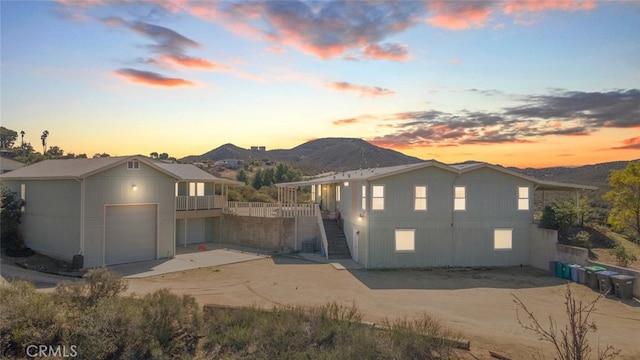 back of property with stairway and a mountain view