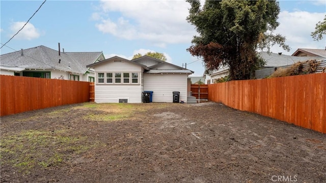 back of property with a fenced backyard