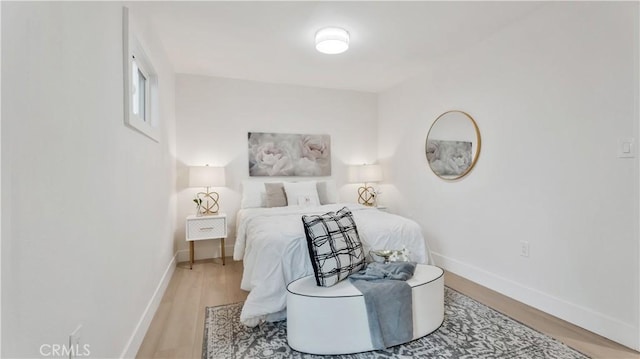 bedroom featuring wood finished floors and baseboards