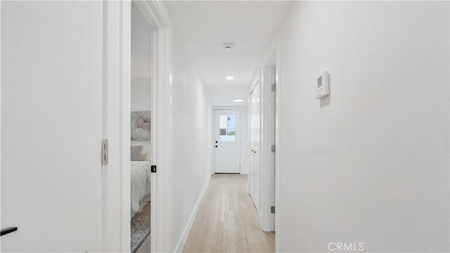 hall with recessed lighting, baseboards, and light wood-style flooring