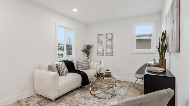 sitting room featuring light wood-style flooring, recessed lighting, and baseboards