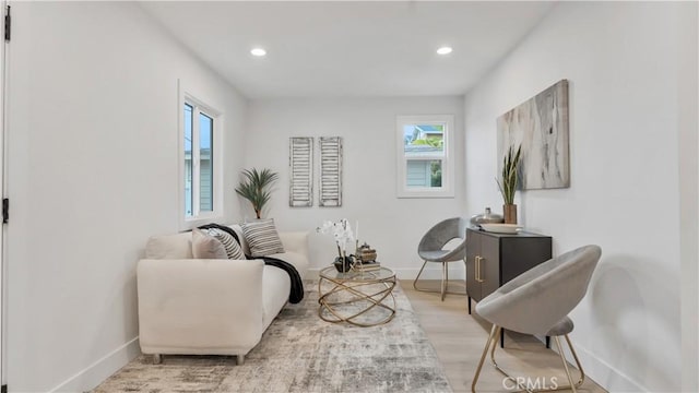 living area with recessed lighting, wood finished floors, and baseboards