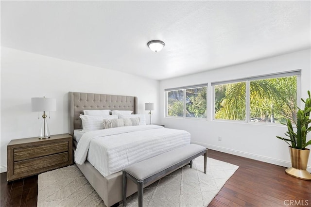 bedroom featuring baseboards and wood-type flooring