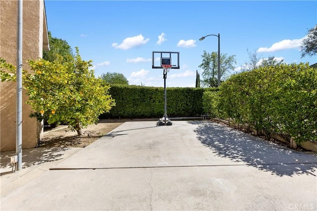 view of sport court featuring fence