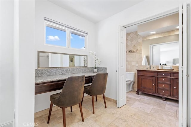 office area featuring baseboards and a sink