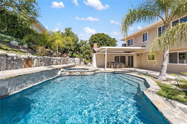 view of swimming pool with an in ground hot tub, a fenced in pool, and a patio