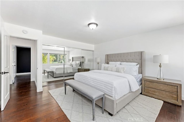 bedroom with wood finished floors and a closet