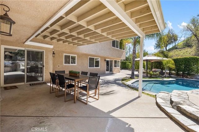 pool featuring outdoor dining area and a patio