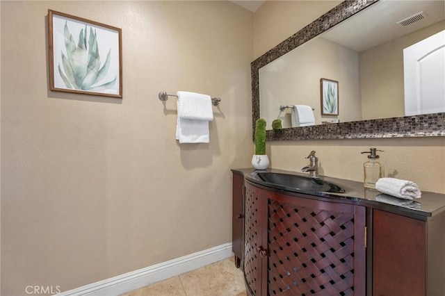 bathroom featuring tile patterned floors, visible vents, vanity, and baseboards