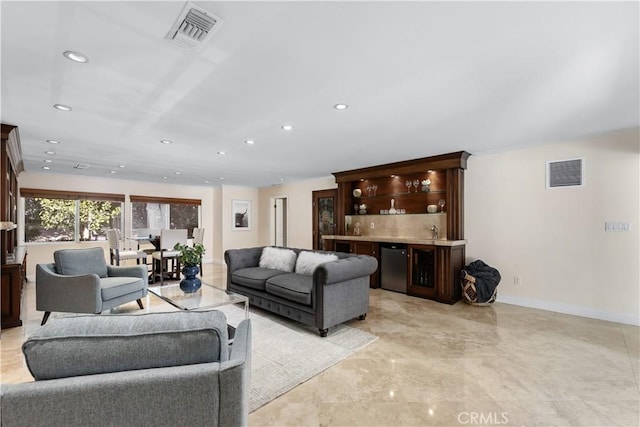 living area featuring recessed lighting, visible vents, and baseboards