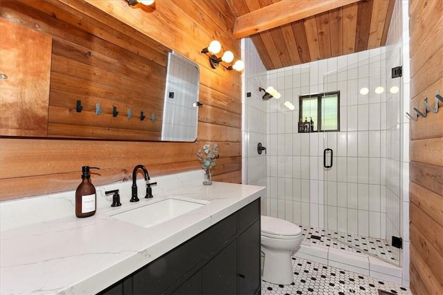 full bathroom featuring wooden walls, a stall shower, vanity, and toilet