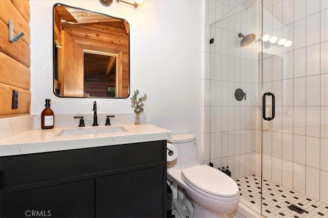 full bathroom with vanity, a shower stall, and toilet