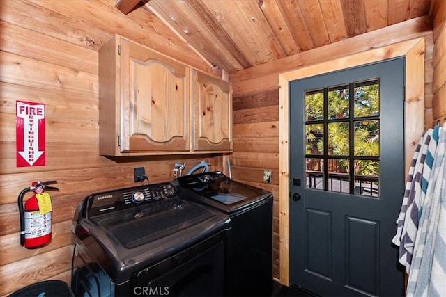 laundry area with cabinet space, wooden ceiling, independent washer and dryer, and wood walls