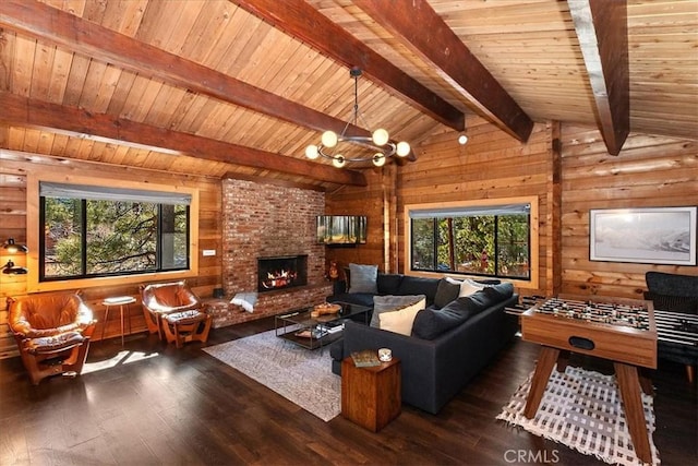 living room with hardwood / wood-style floors, plenty of natural light, wood walls, and vaulted ceiling with beams