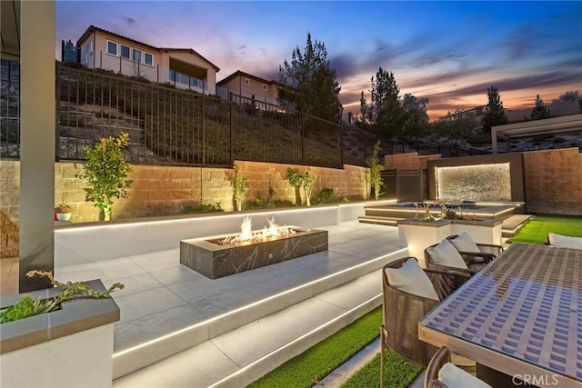 20535 W Bluebird Ct, Porter Ranch, CA 91326 - patio terrace at dusk with an outdoor fire pit and fence