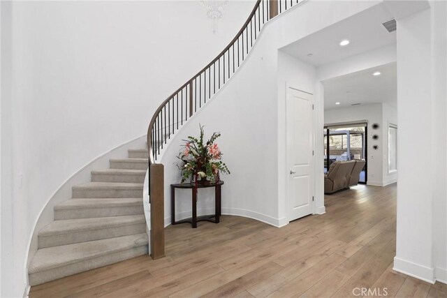 20535 W Bluebird Ct, Porter Ranch, CA 91326 - stairs with hardwood / wood-style flooring, baseboards, and recessed lighting