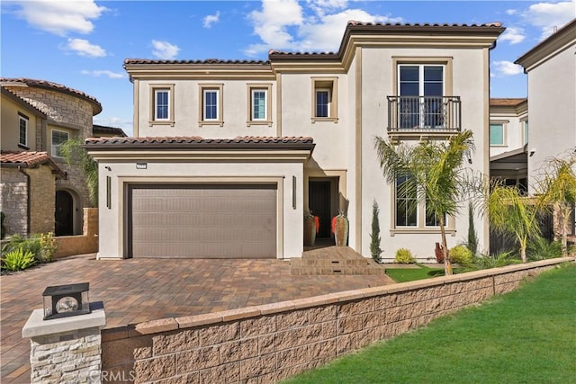 20535 W Bluebird Ct, Porter Ranch, CA 91326 - mediterranean / spanish house featuring stucco siding, a garage, decorative driveway, and a balcony