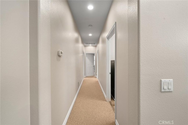 hall with light carpet, visible vents, recessed lighting, and baseboards