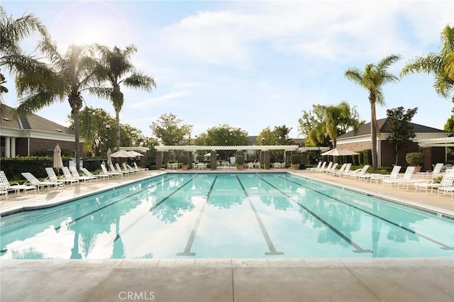 pool featuring fence and a patio area