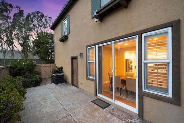 exterior space featuring a gate, cooling unit, and fence