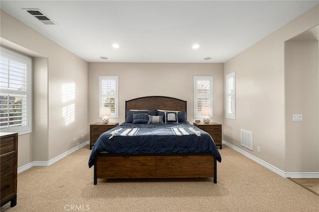 bedroom with recessed lighting, baseboards, visible vents, and light carpet