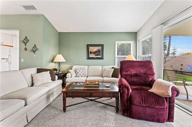 living room featuring visible vents and plenty of natural light